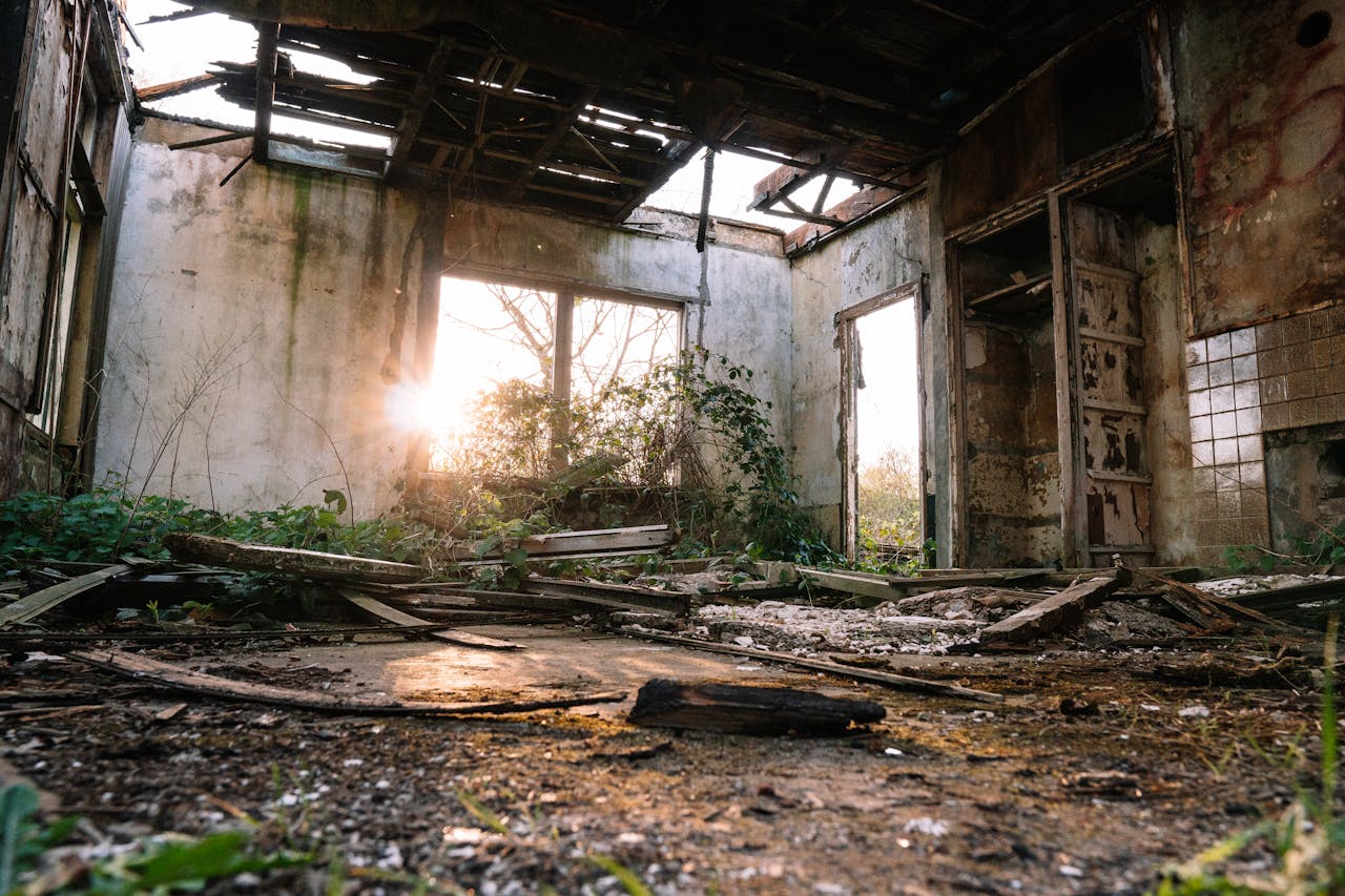 Home Eerie interior of an abandoned building in ruins with sunlight filtering through.
